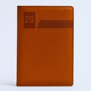 Tan diary with embossed “26” and line pattern